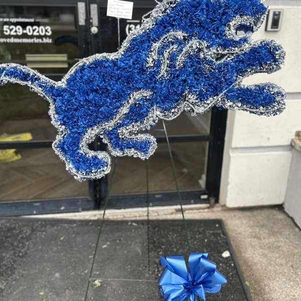 Blue and silver floral horse-shaped standing tribute on an easel