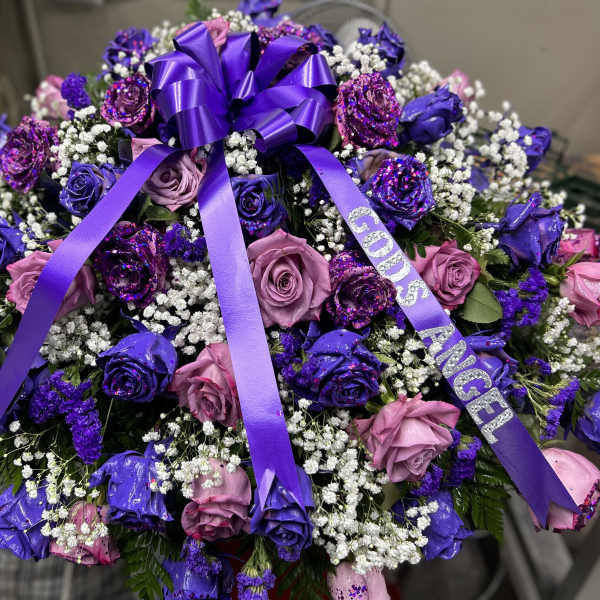 Purple and pink rose bouquet with a purple ribbon bow