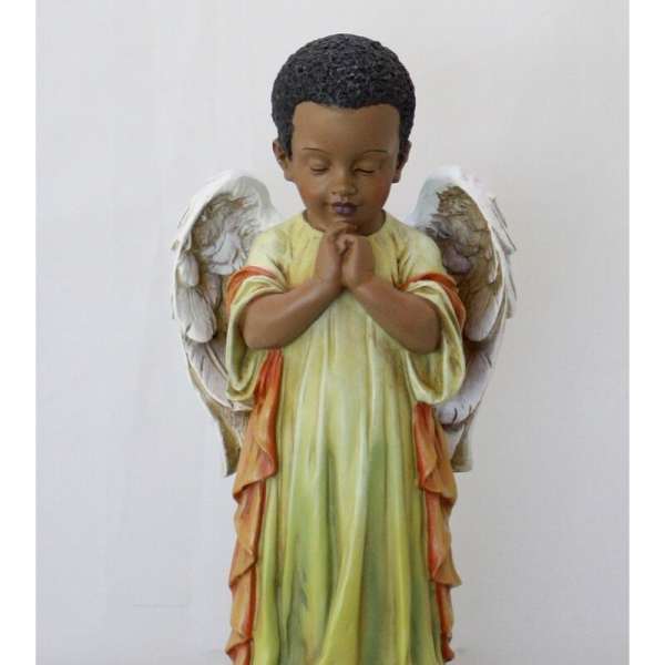 Praying angel figurine in a green robe with white wings
