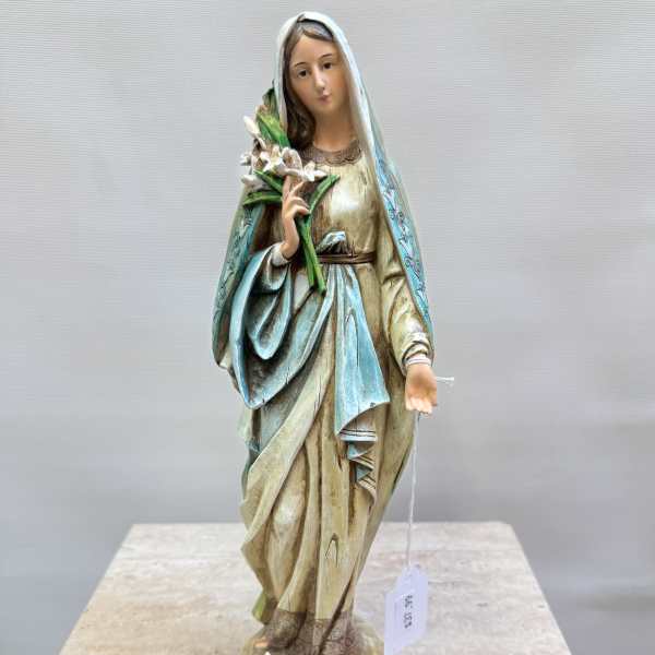 Statue of a veiled woman holding white flowers