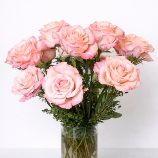 Pink roses arranged in a clear glass vase