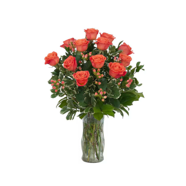 Orange roses arranged in a clear glass vase