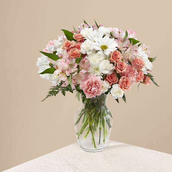 Pink and white mixed bouquet in a clear glass vase