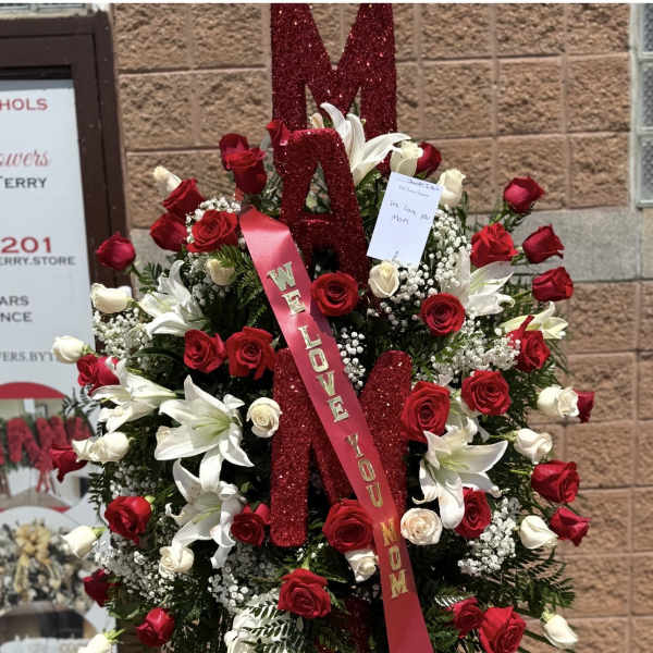 Large standing floral tribute with red and white roses and lilies