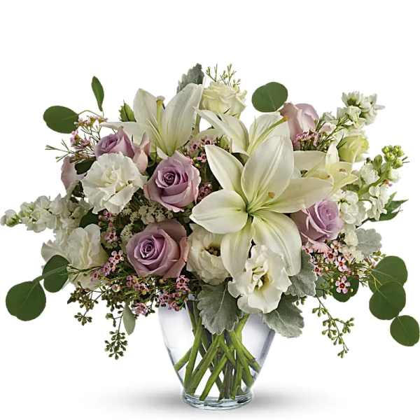 Lavender roses and white lilies in a clear glass vase