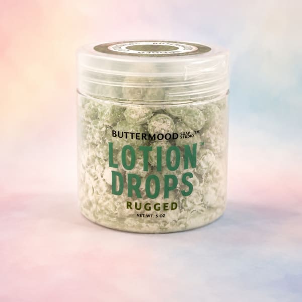 Jar of lotion drops with a pastel background