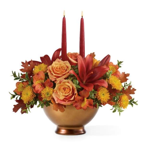 Autumn floral centerpiece with two red taper candles in a gold bowl