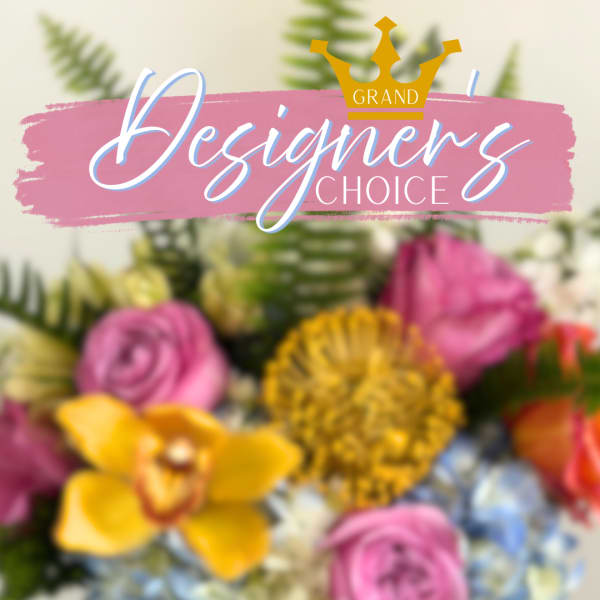 Blurred floral arrangement behind a pink "Designer’s Choice" banner