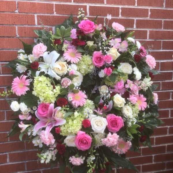Large pink and white floral standing spray with lilies and roses