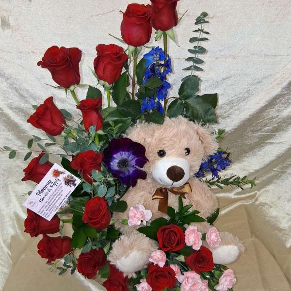 Elegant arrangement with bear and red roses in spiral
