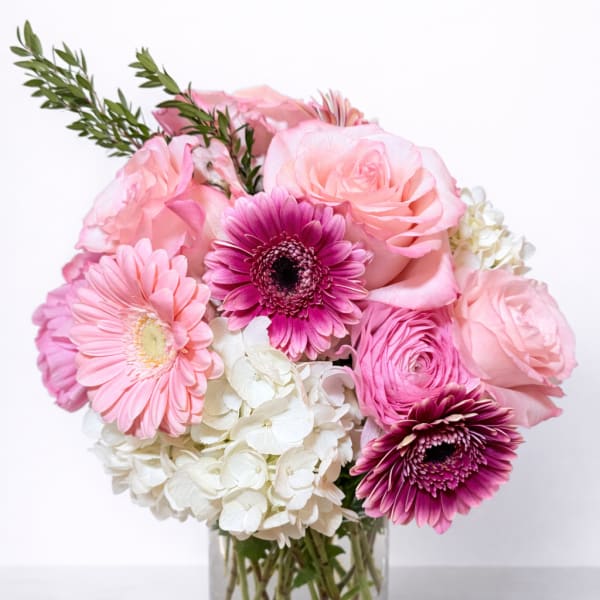 Pink and white mixed bouquet in a clear glass vase