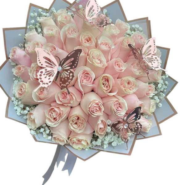 Bouquet of pale pink roses with butterfly decorations