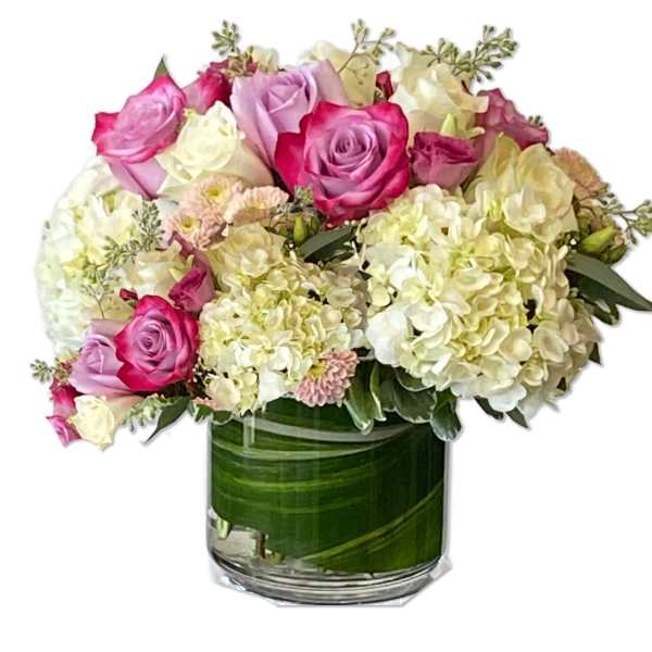 Pink and white roses with hydrangeas in a glass vase