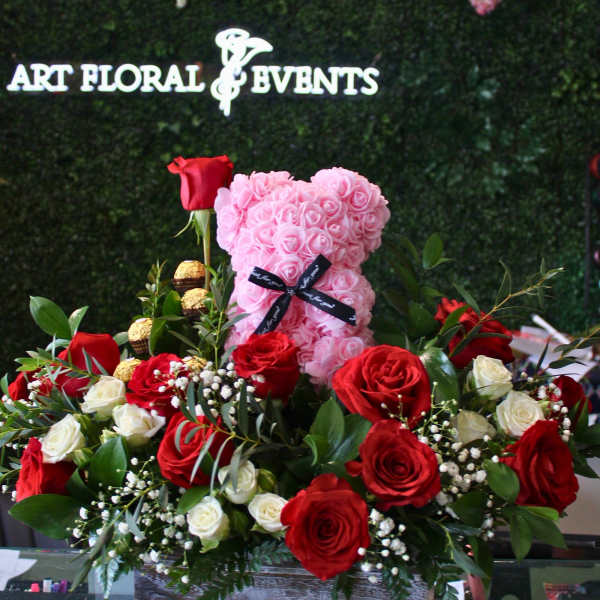 Heart-shaped pink rose teddy with red and white roses in a wooden box