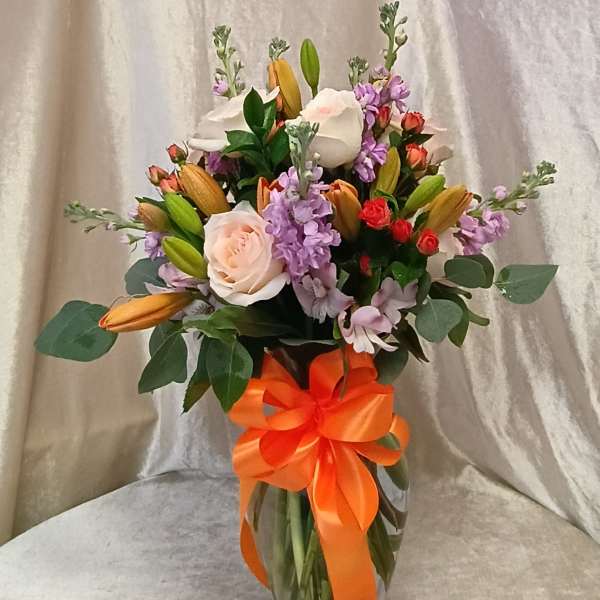 Elegant arrangement pink roses, lavender snap dragons, orange lily