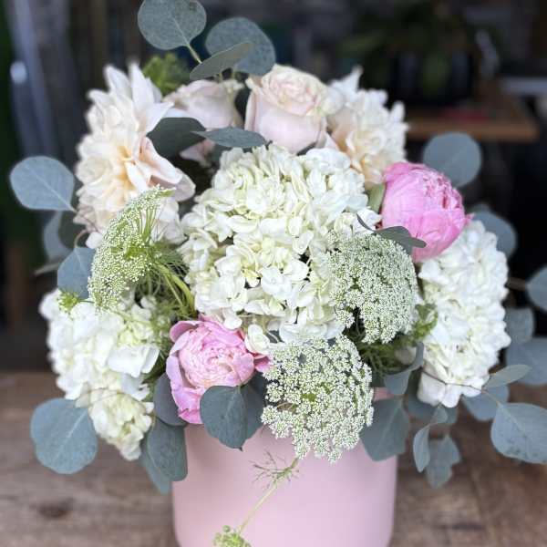 Pink and white bouquet in a pastel pink vase