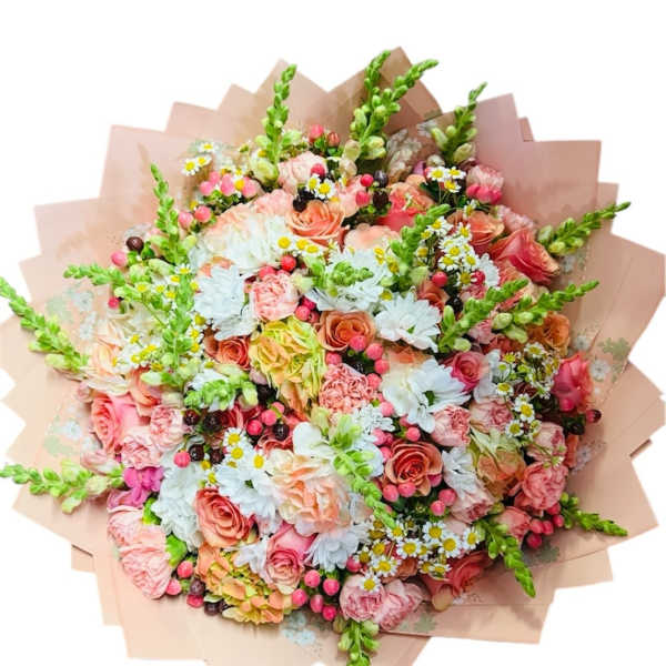 Large pastel bouquet of roses, daisies, and snapdragons wrapped in blush paper
