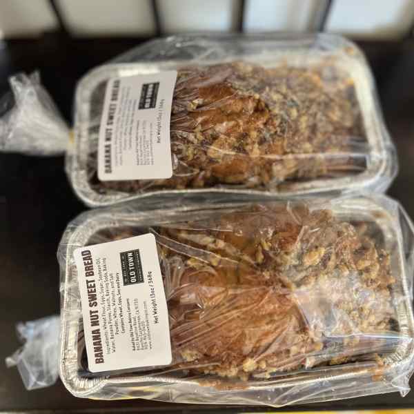 Two packaged loaves of banana nut sweet bread on a table