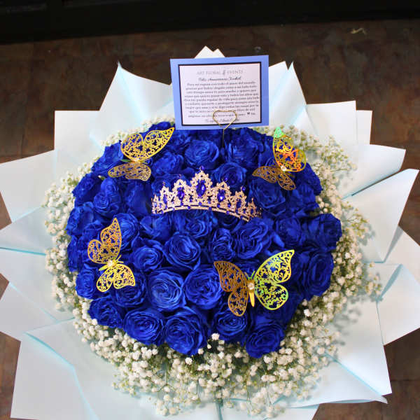 Blue rose bouquet with a tiara and butterfly decorations