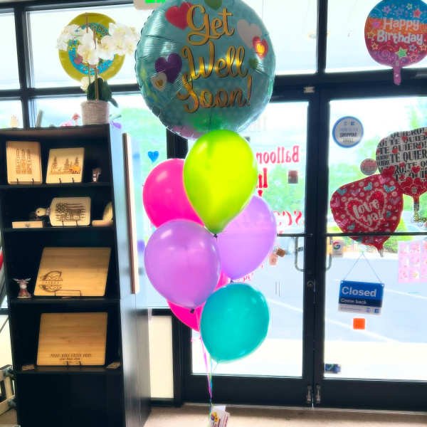 Cluster of colorful birthday and get well balloons in a store entrance