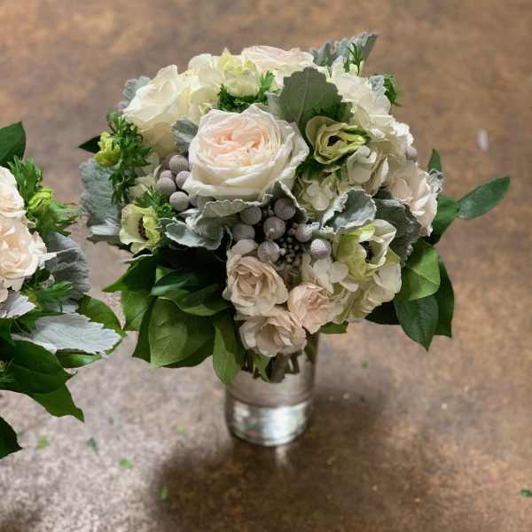 Bouquet of pale roses and white hydrangeas in a metal vase