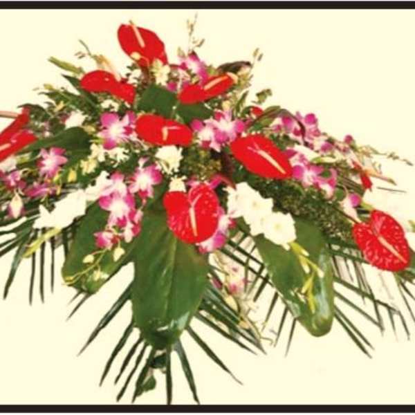 Tropical floral arrangement with red anthuriums and pink orchids