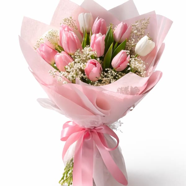 Pink and white tulip bouquet wrapped in pale pink paper with a ribbon