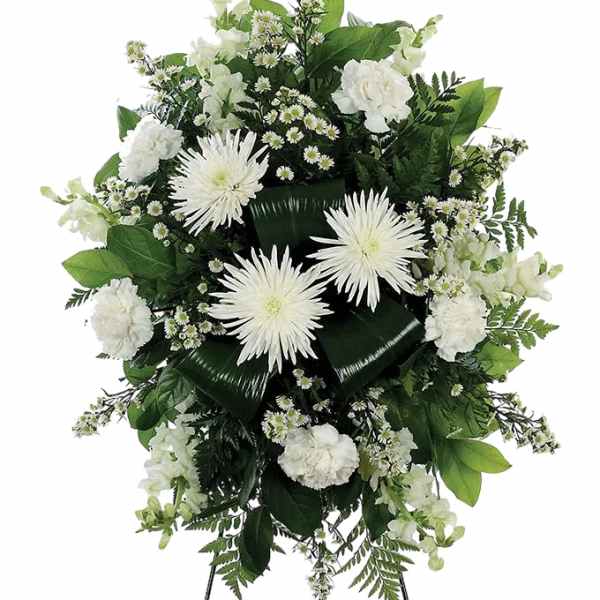 White floral standing spray with daisies and carnations on a black easel