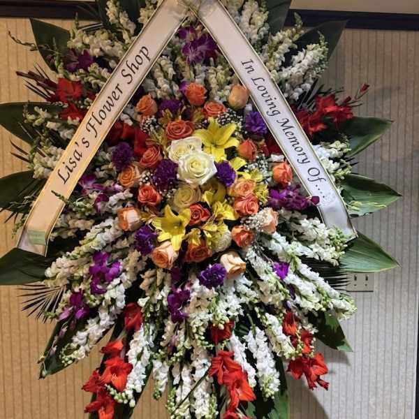 Large standing sympathy wreath with mixed roses and orchids on a ribboned easel