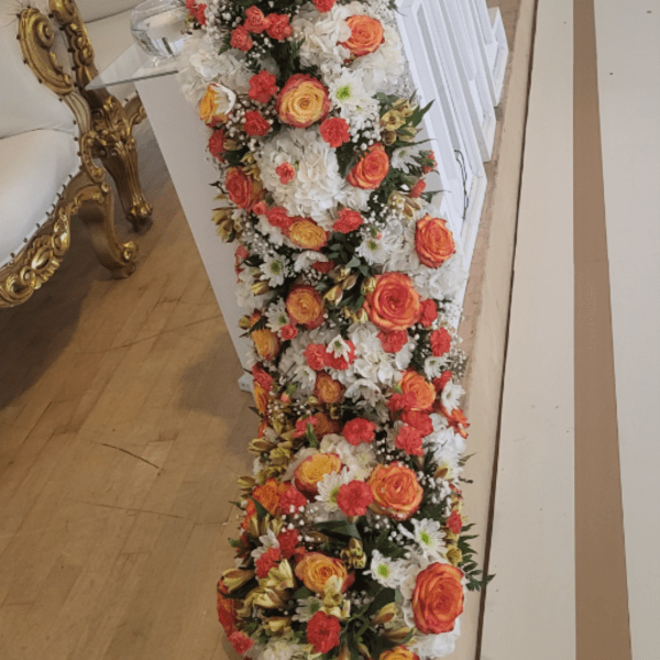 Long hanging main center piece for main table orange roses with white flowers sold by foot $55.00