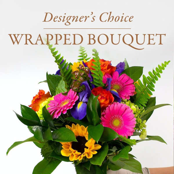 Colorful wrapped bouquet with gerbera daisies, sunflowers, and roses