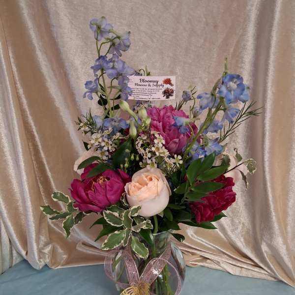 Peonies in glass vase