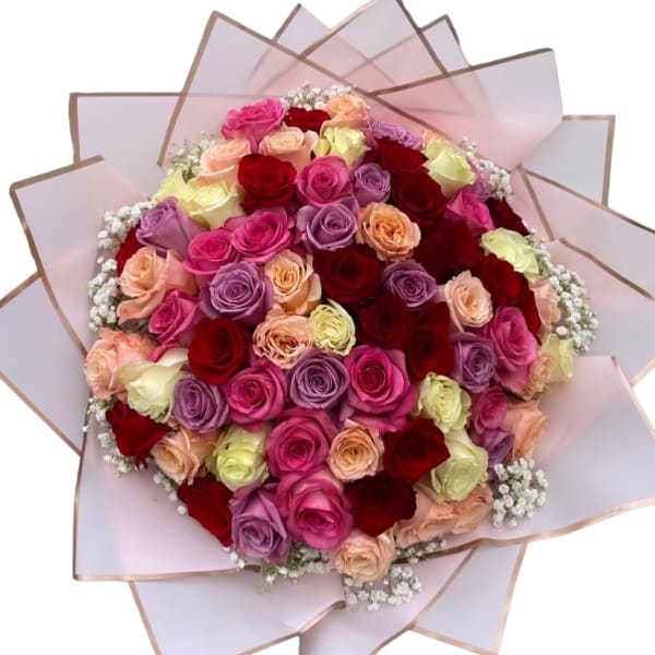 Round bouquet of multicolored roses wrapped in pale pink paper