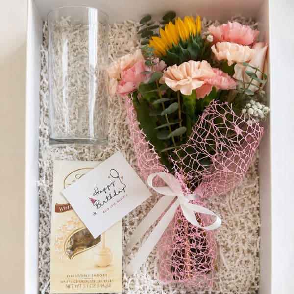 Gift box with a small bouquet, glass vase, and chocolate truffles
