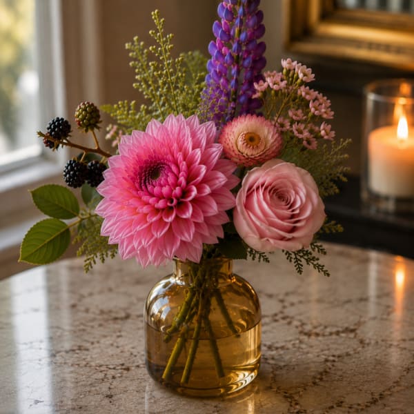 Pink and purple mixed bouquet in an amber glass vase