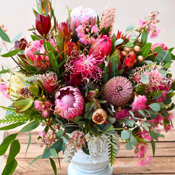 Pink and red mixed bouquet in a white vase