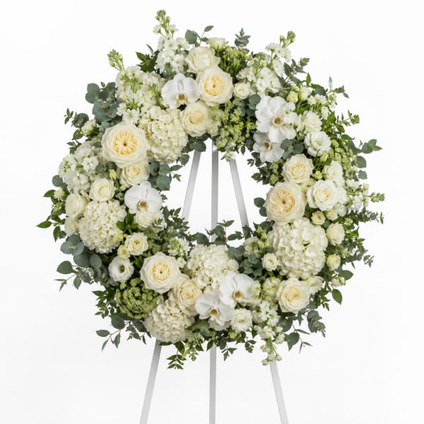 White floral wreath on a standing easel