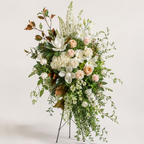 Tall white and blush floral standing arrangement on a metal easel