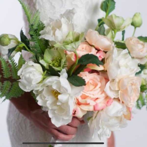 Bouquet of white and peach roses with greenery