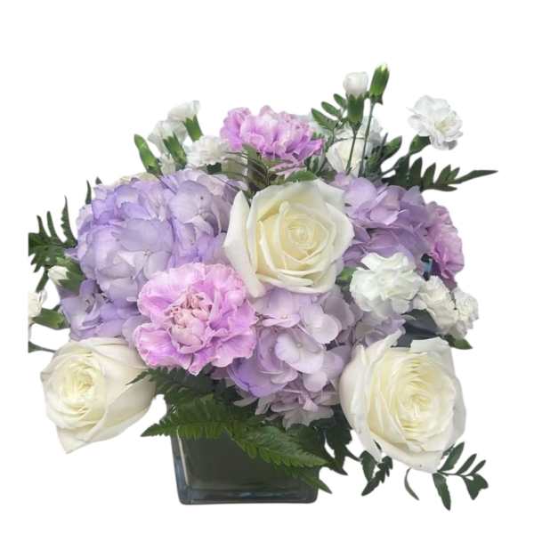 Lavender hydrangeas and white roses in a square glass vase