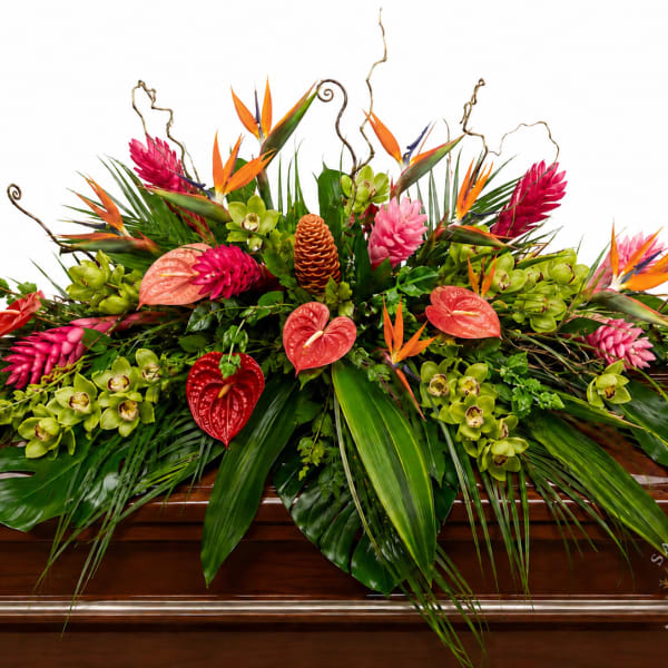 Tropical floral casket spray with pink, orange, and green blooms