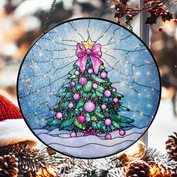Round hanging ornament with a decorated Christmas tree and pink bow