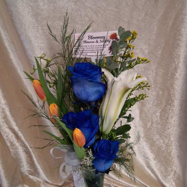3 blue roses with tulips