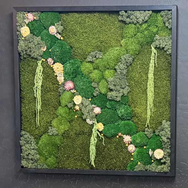 Framed green moss wall with small pastel flowers