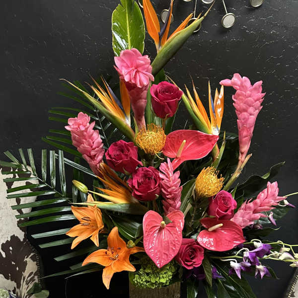 Tropical arrangement with pink roses, anthuriums, lilies, and bird-of-paradise