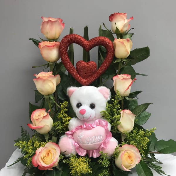 Rose arrangement with a teddy bear and glitter heart decoration