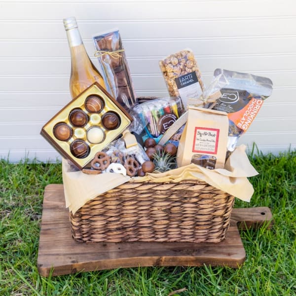 Gift basket with chocolates, pretzels, popcorn, and a bottle of wine