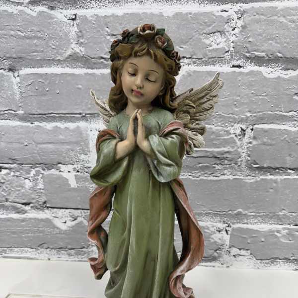 Decorative angel figurine with folded hands and wings