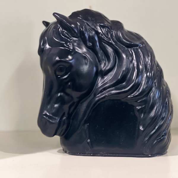 Black horse-shaped decorative object on a shelf