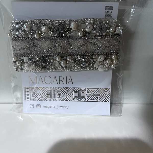 Beaded silver bracelet in a clear plastic package